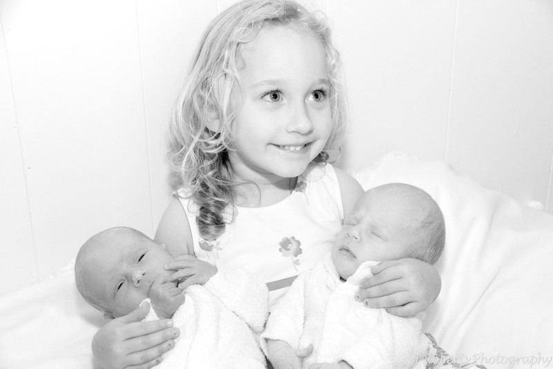 Older sister with newborn twin boys - newborn portrait photography sydney